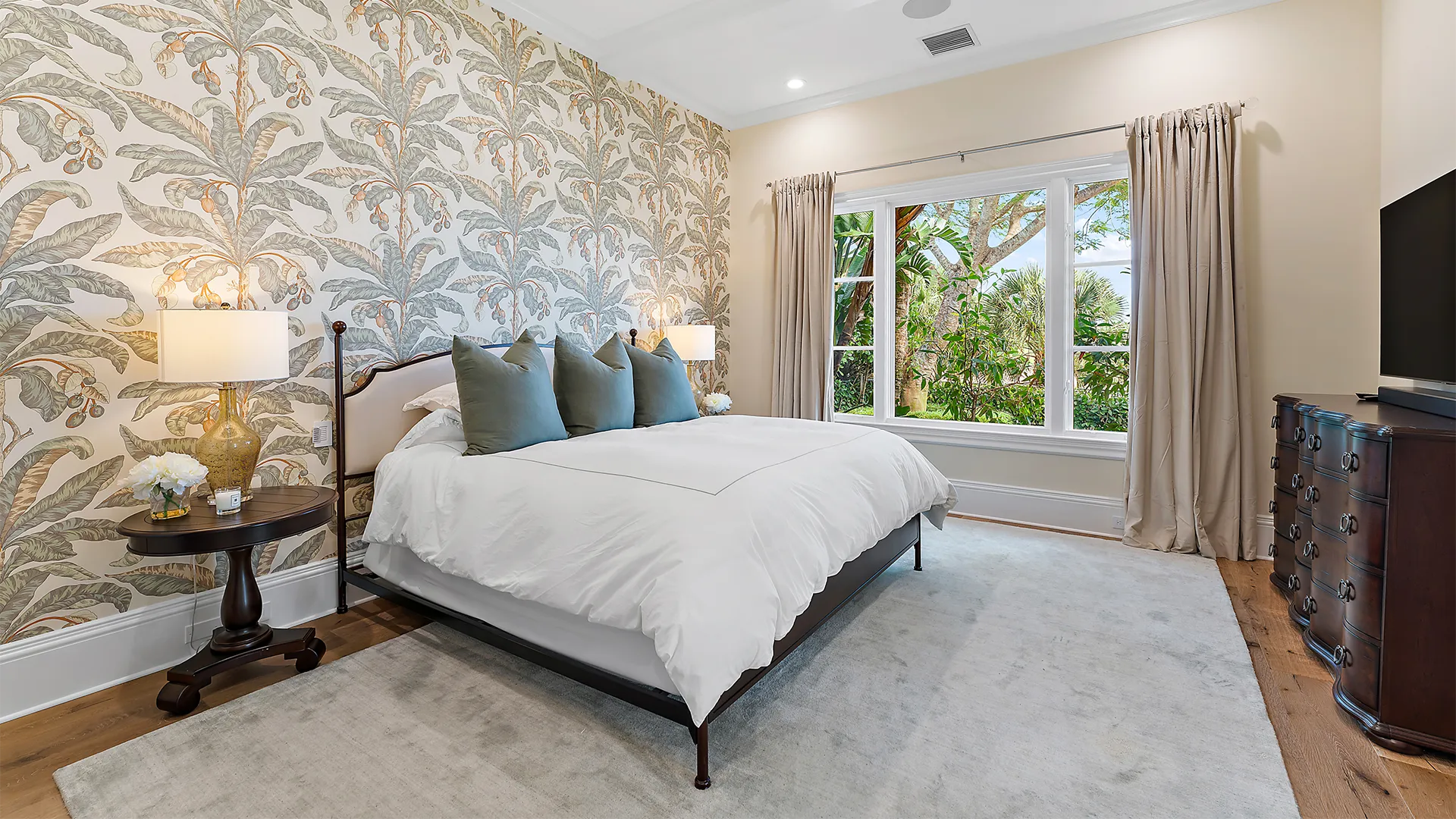 Exquisite bedroom designed with a generous bed and a contemporary television.