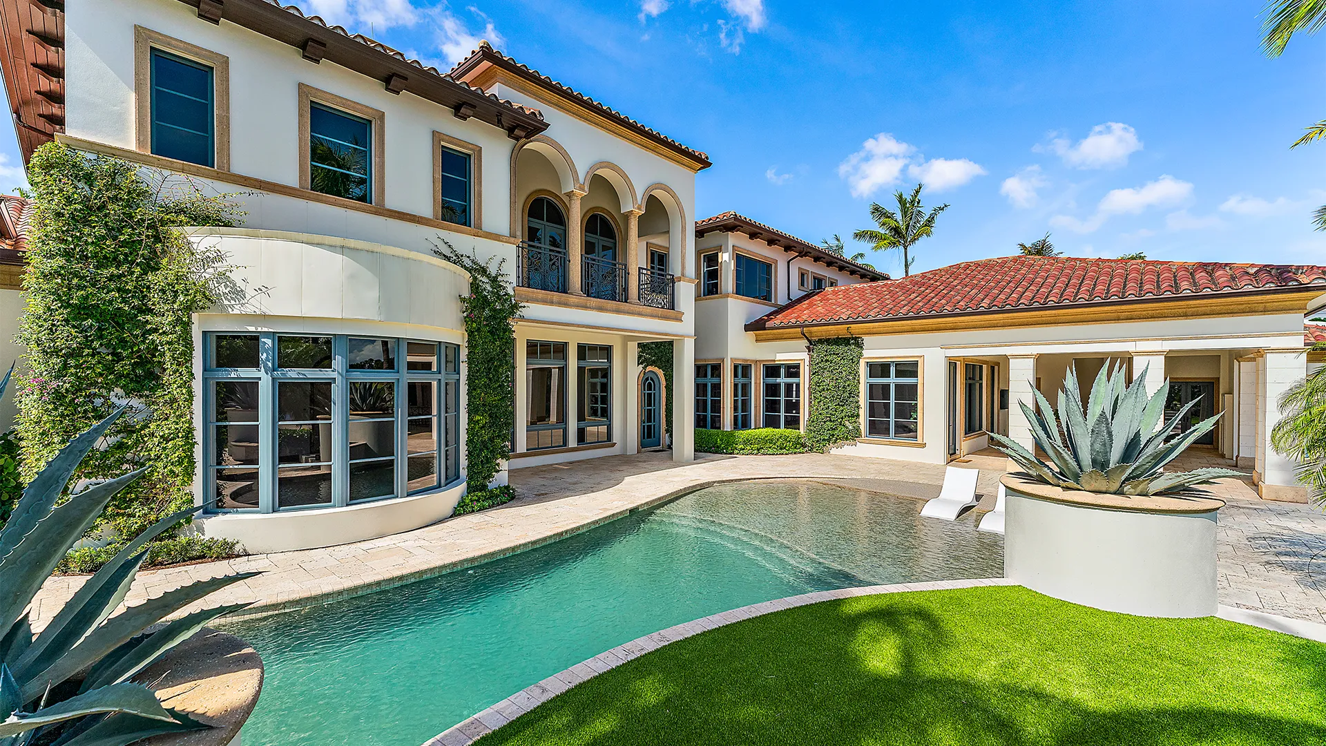 Expansive New Mediterranean style residence with a stunning pool and chic patio, embodying a sophisticated oasis for leisure and gatherings.