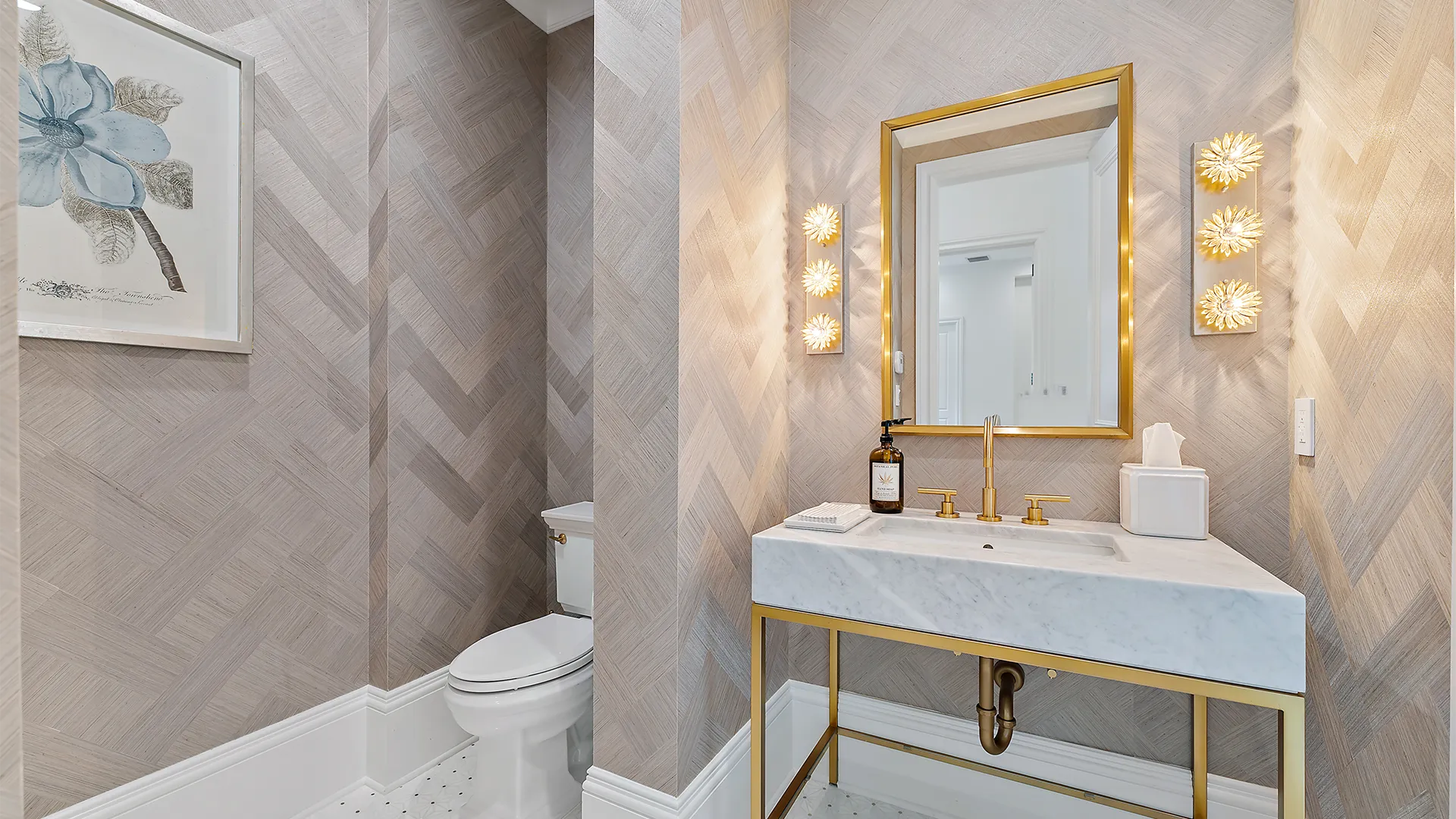 Opulent bathroom showcasing a stunning gold sink and a decorative mirror.