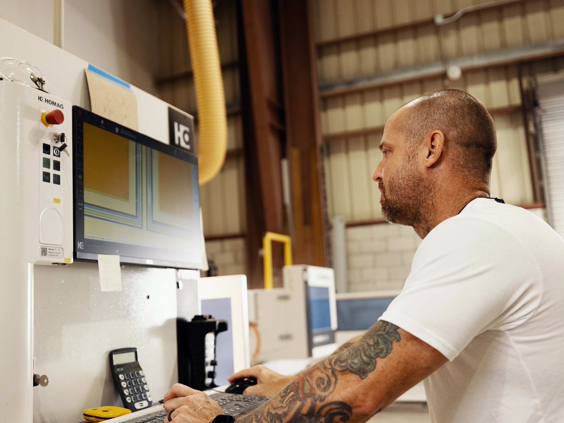 Man is operating a machine, demonstrating precision and dedication in his work.