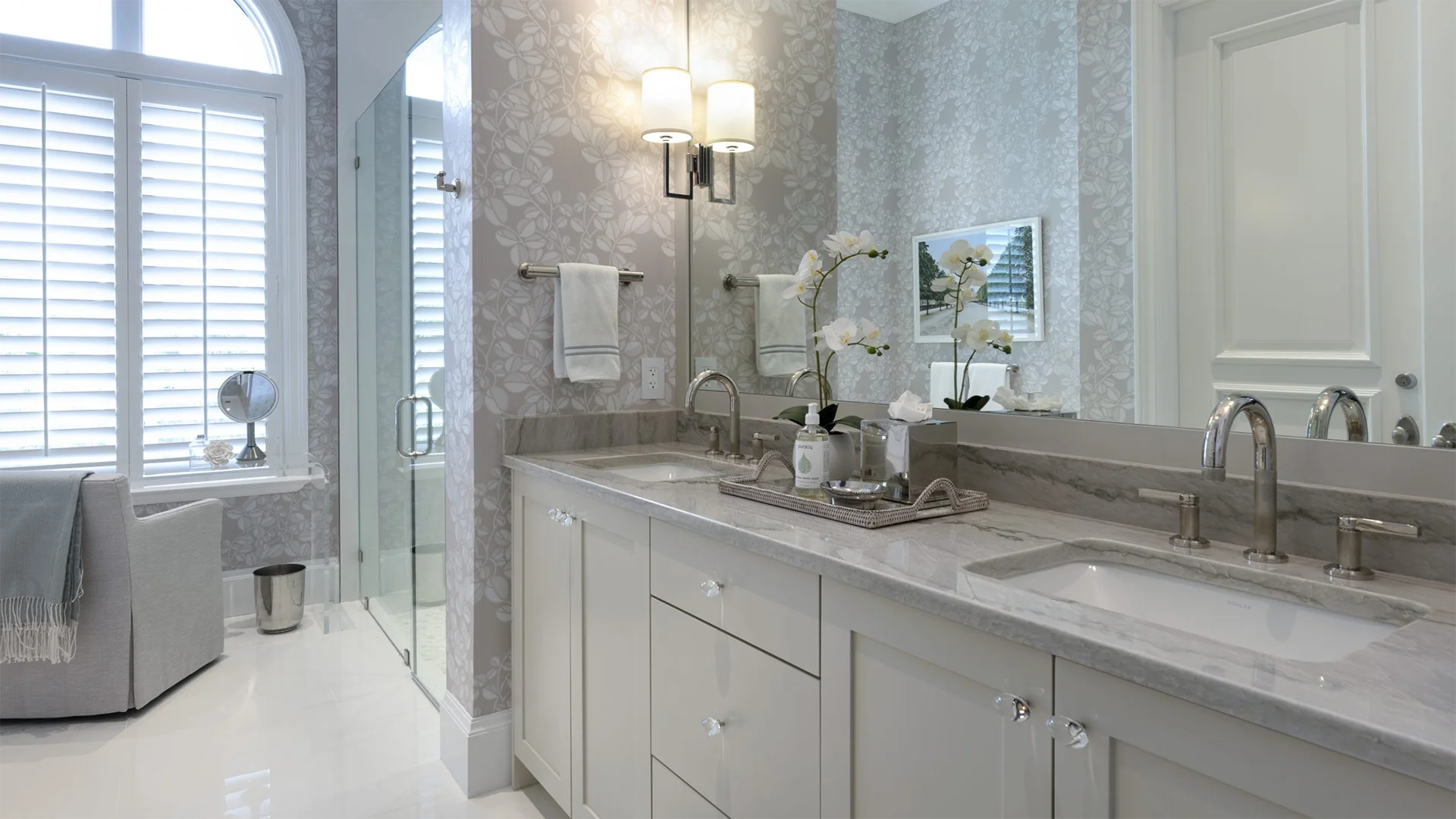 Stylish bathroom interior featuring a double sink and a comfortable tub.