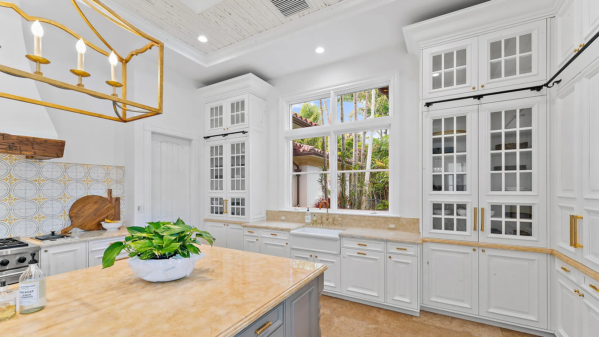 Sophisticated kitchen design that combines sleek white cabinets with glamorous gold accents.