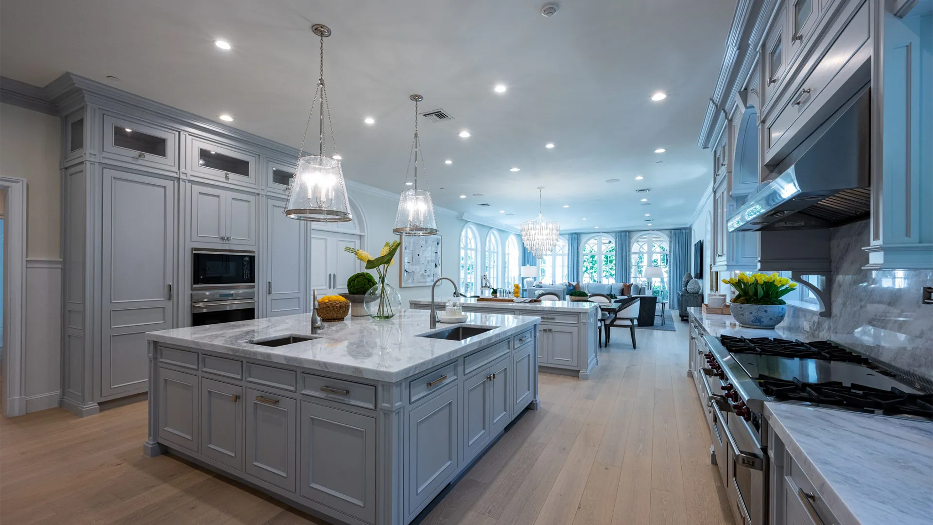 Striking kitchen featuring a beautiful Dolomite marble island, bathed in light, that connects to a charming dining room.