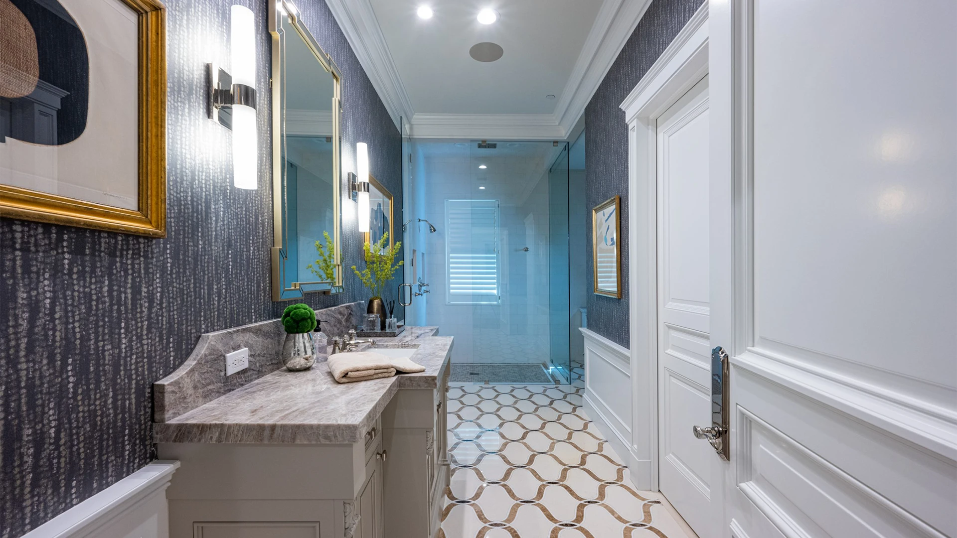 Modern bathroom design showcasing a white door, peaceful blue walls, and rich textures, artfully accented with tasteful decor.