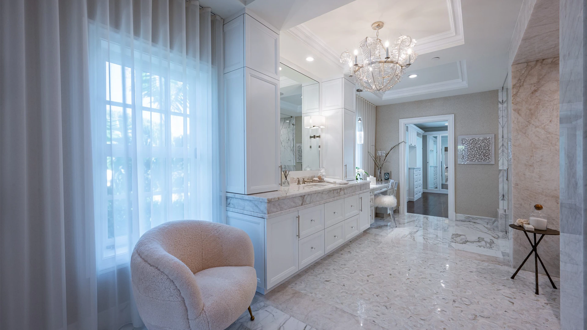 Chic bathroom showcasing bright white walls and luxurious marble flooring, enhanced by understated light pink shades.