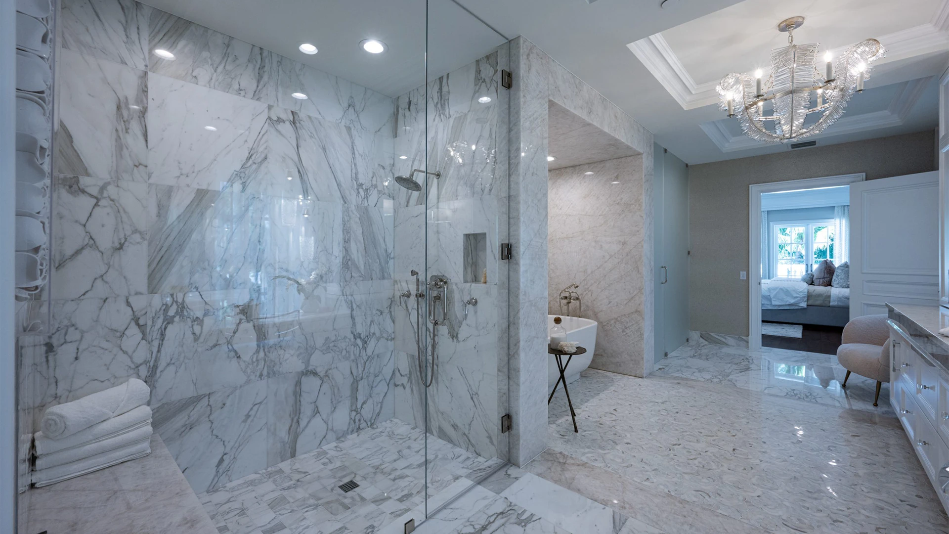 Indulgent bathroom featuring shiny marble floors and a spacious walk-in shower.