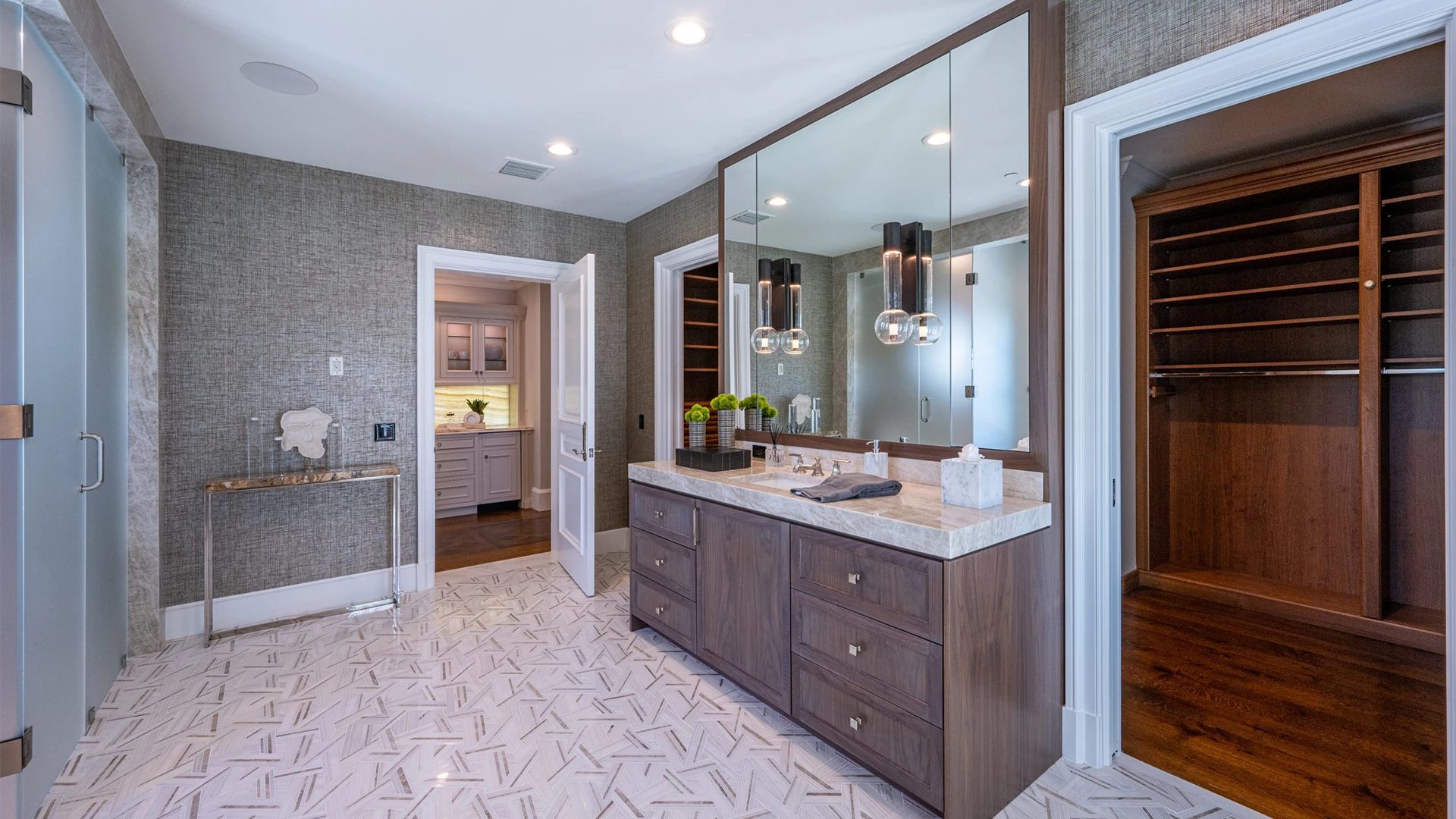 Magnificent bathroom that offers a spacious walk-in closet and an elegant vanity.