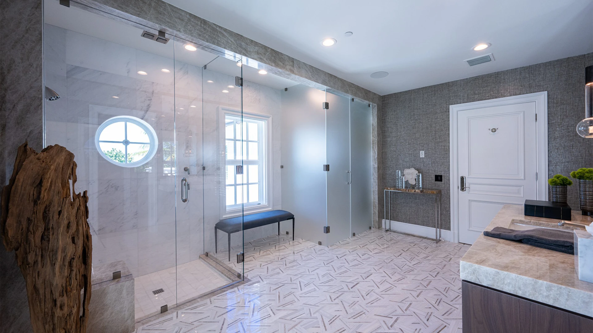 Luminous bathroom highlighted by a sleek glass shower door and a sophisticated sink.