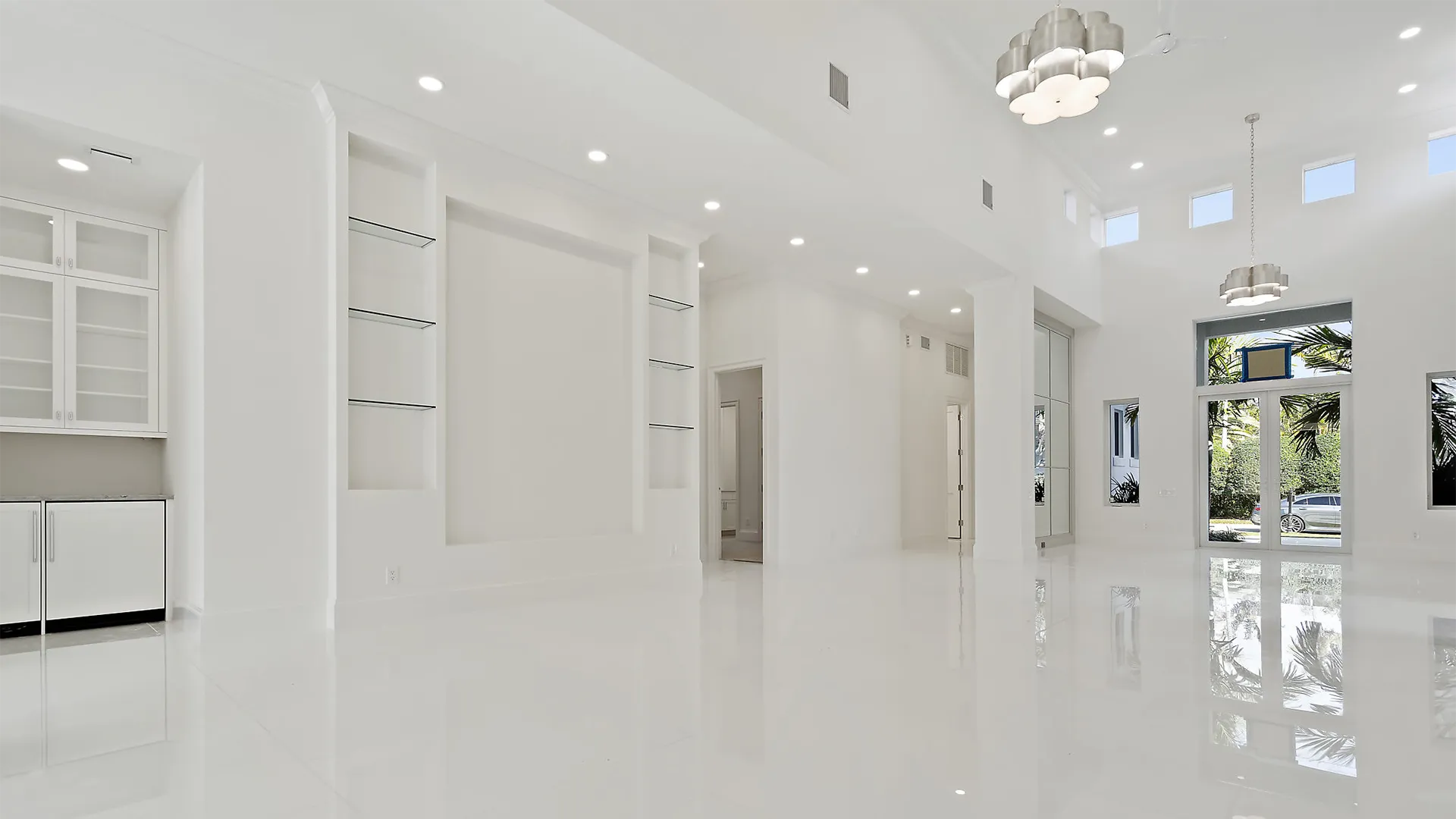 Refined white passageway showcasing a magnificent glass door.