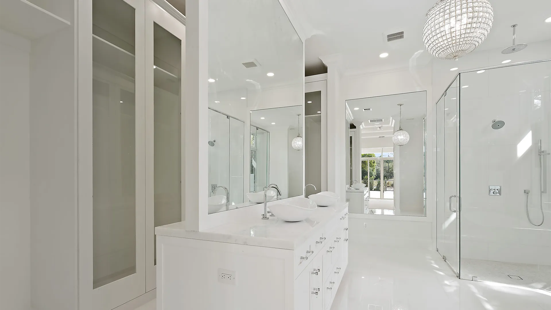 Contemporary bathroom design with a large mirror and a luxurious walk-in shower.