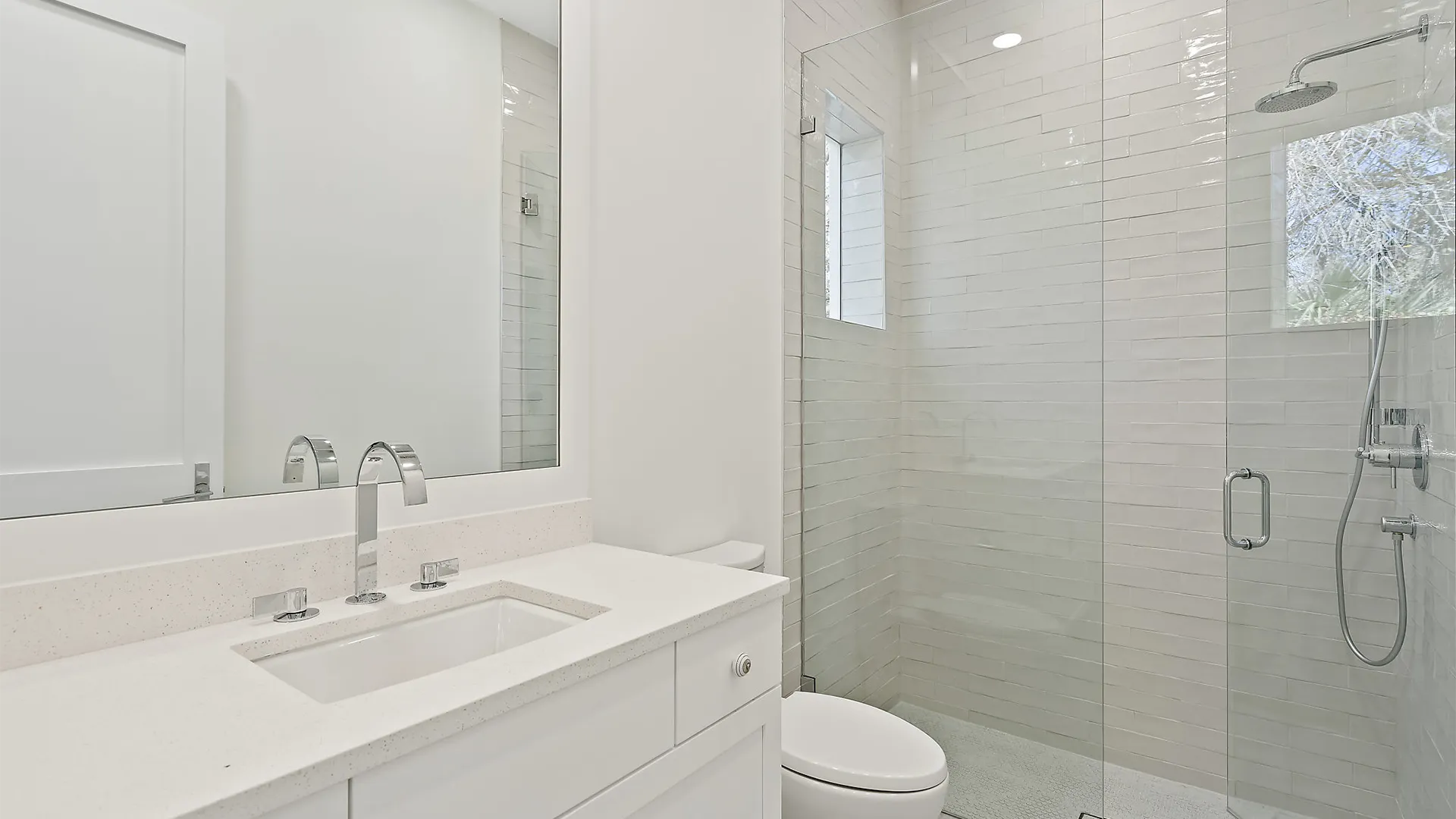 Contemporary bathroom design with a large mirror and a luxurious walk-in shower.