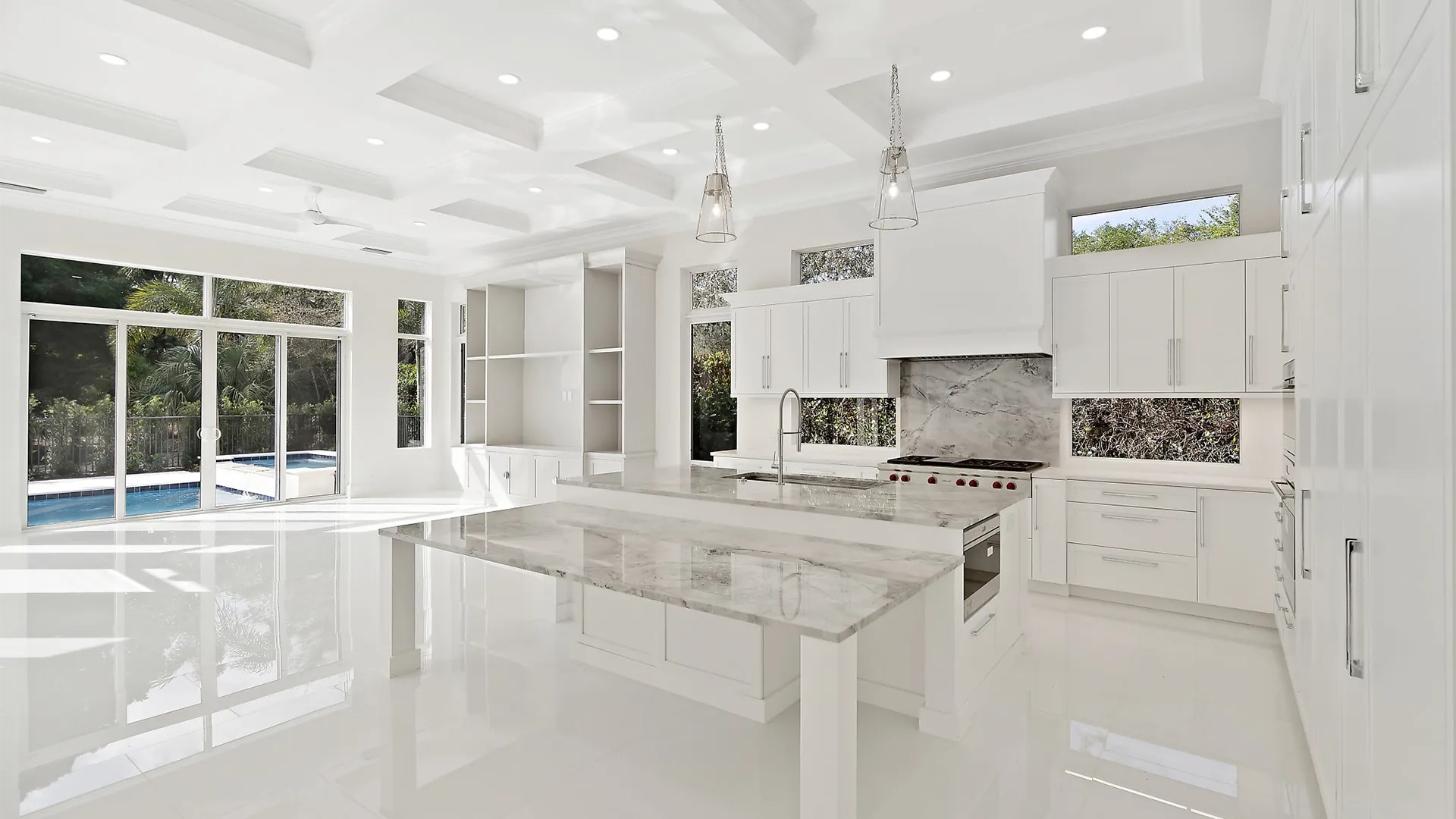Large and airy kitchen with sleek white finishes and exquisite marble countertops.