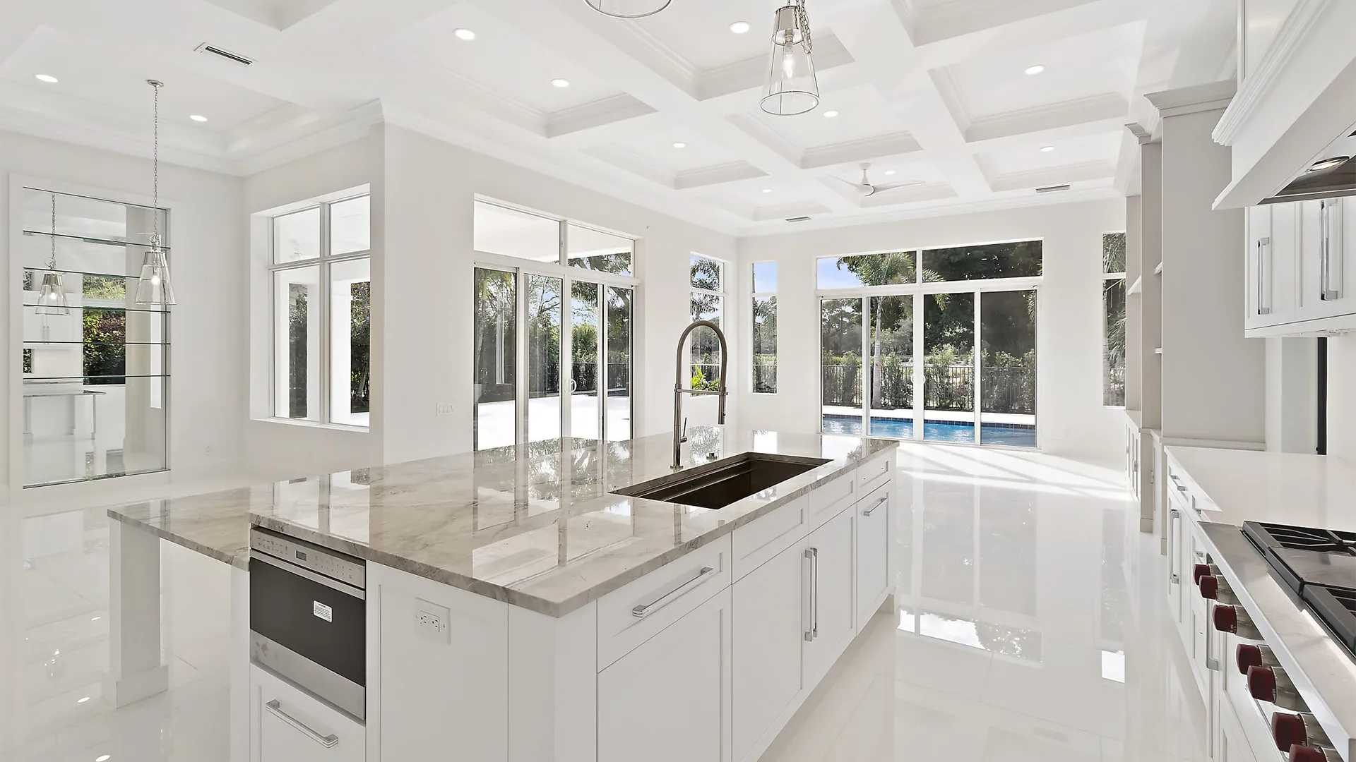 Large and airy kitchen with sleek white finishes and exquisite marble countertops.