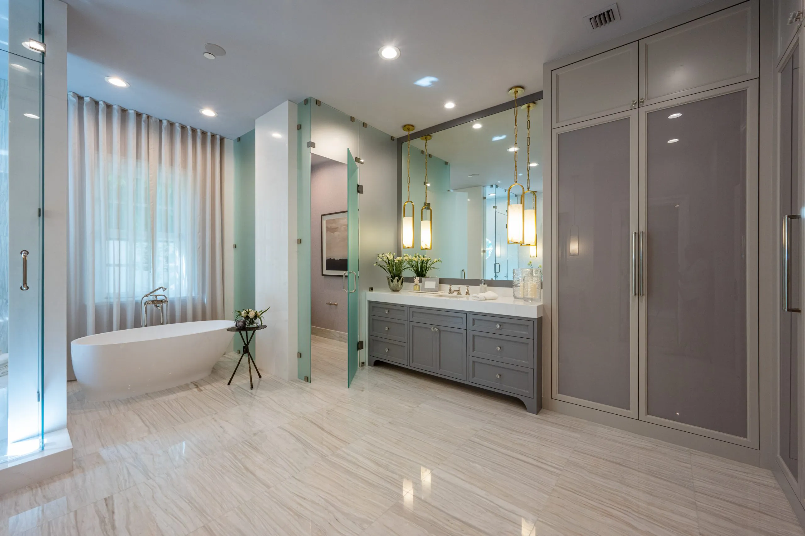Bathroom showcasing a large white tub, a sleek glass shower, and soft lighting for a tranquil retreat.