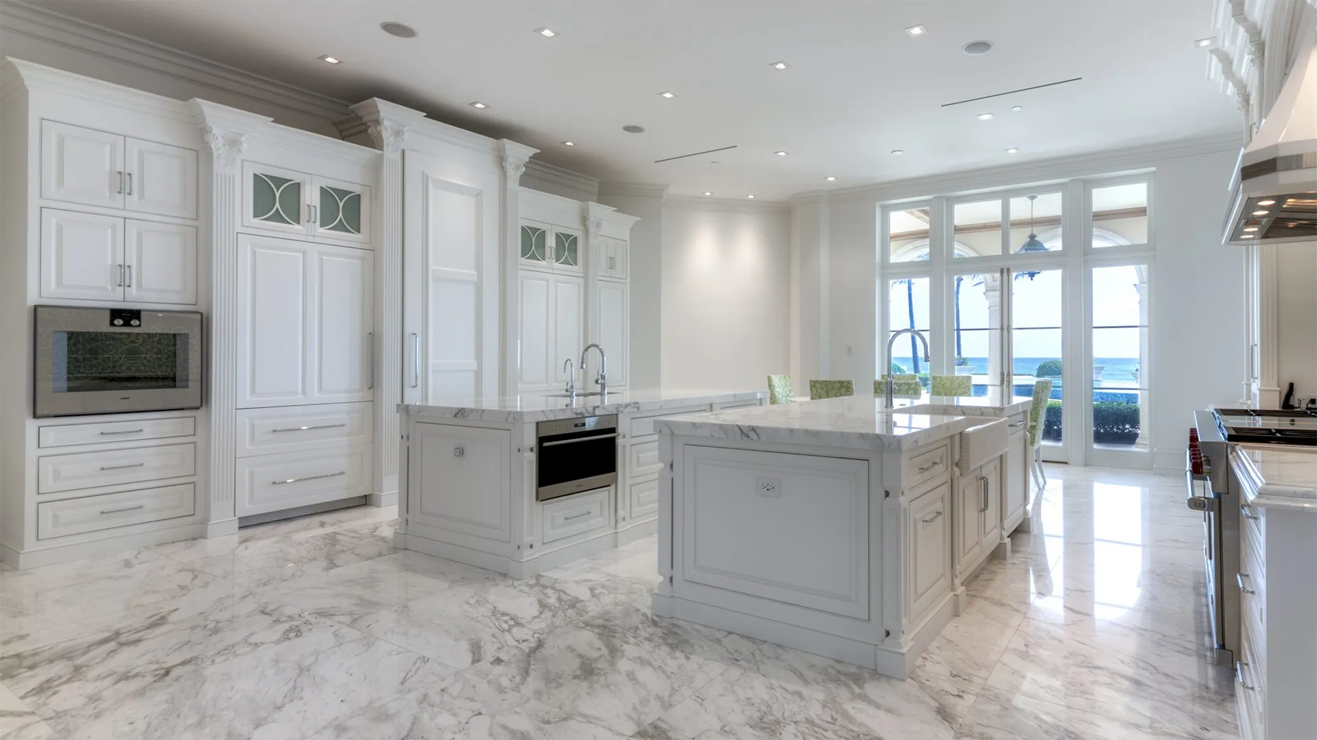 White kitchen with stunning marble countertops, creating a bright and inviting culinary space.