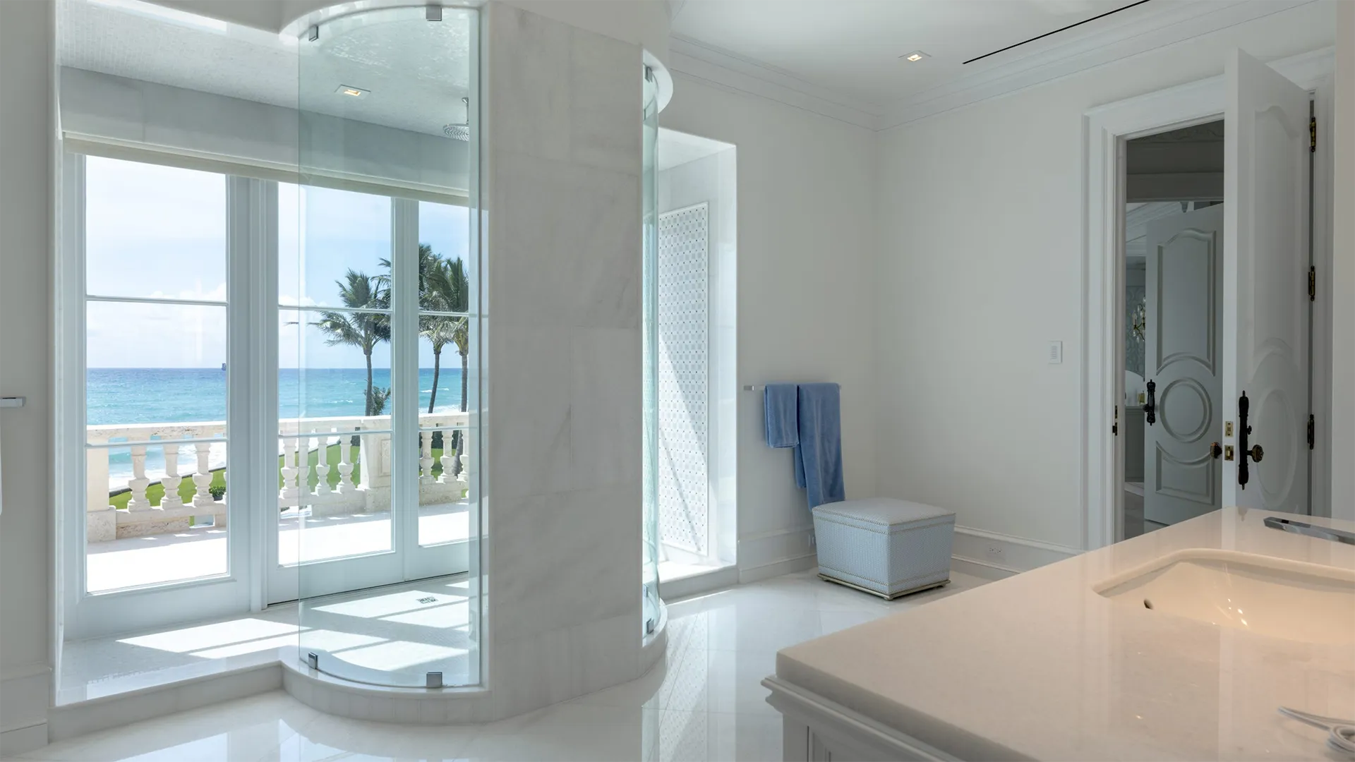 Bathroom featuring a large window that offers breathtaking views of the serene ocean beyond.