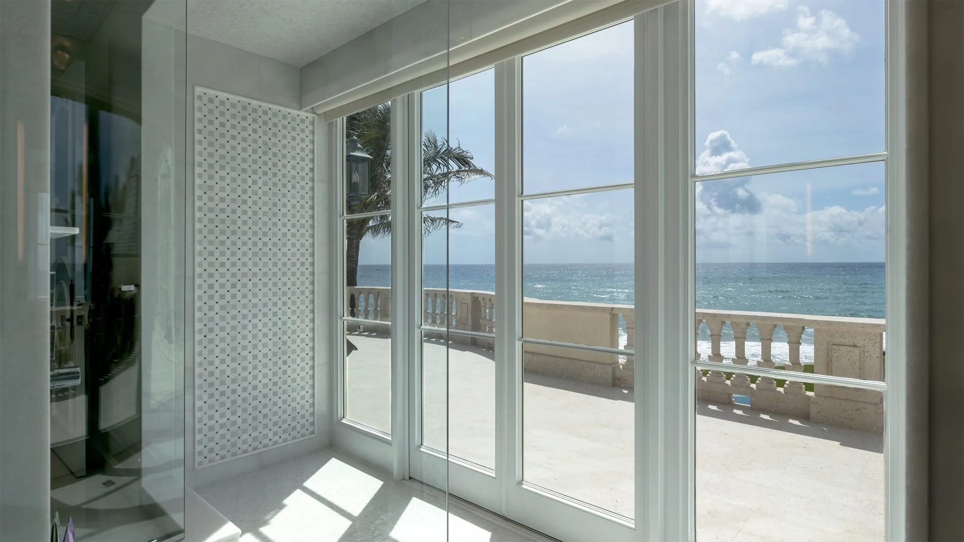 Bathroom featuring a large window that offers breathtaking views of the serene ocean beyond.