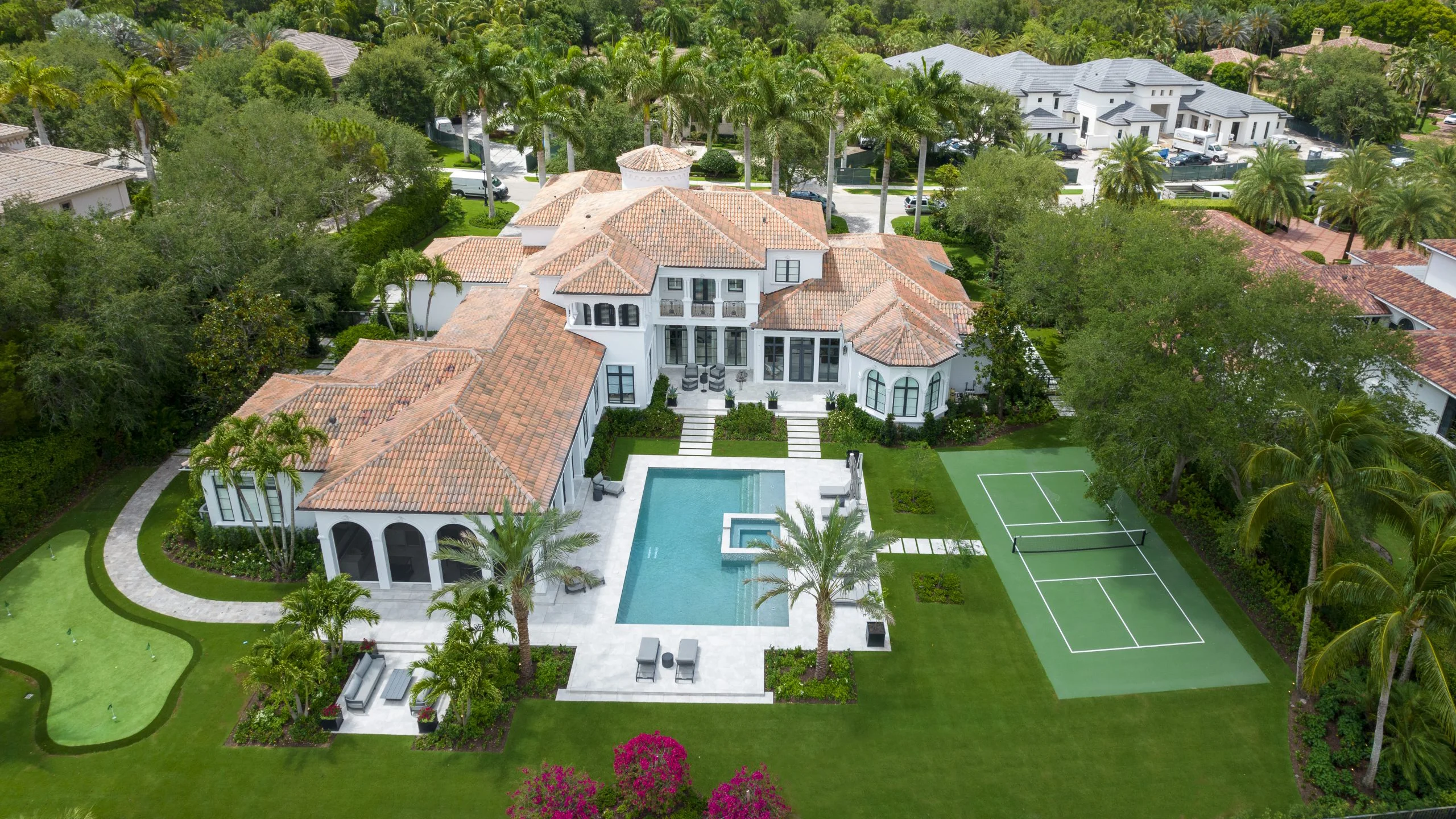 Luxurious Modern Mediterranean Palm Beach residence captured from above, highlighting its stunning design and beautiful landscaping.