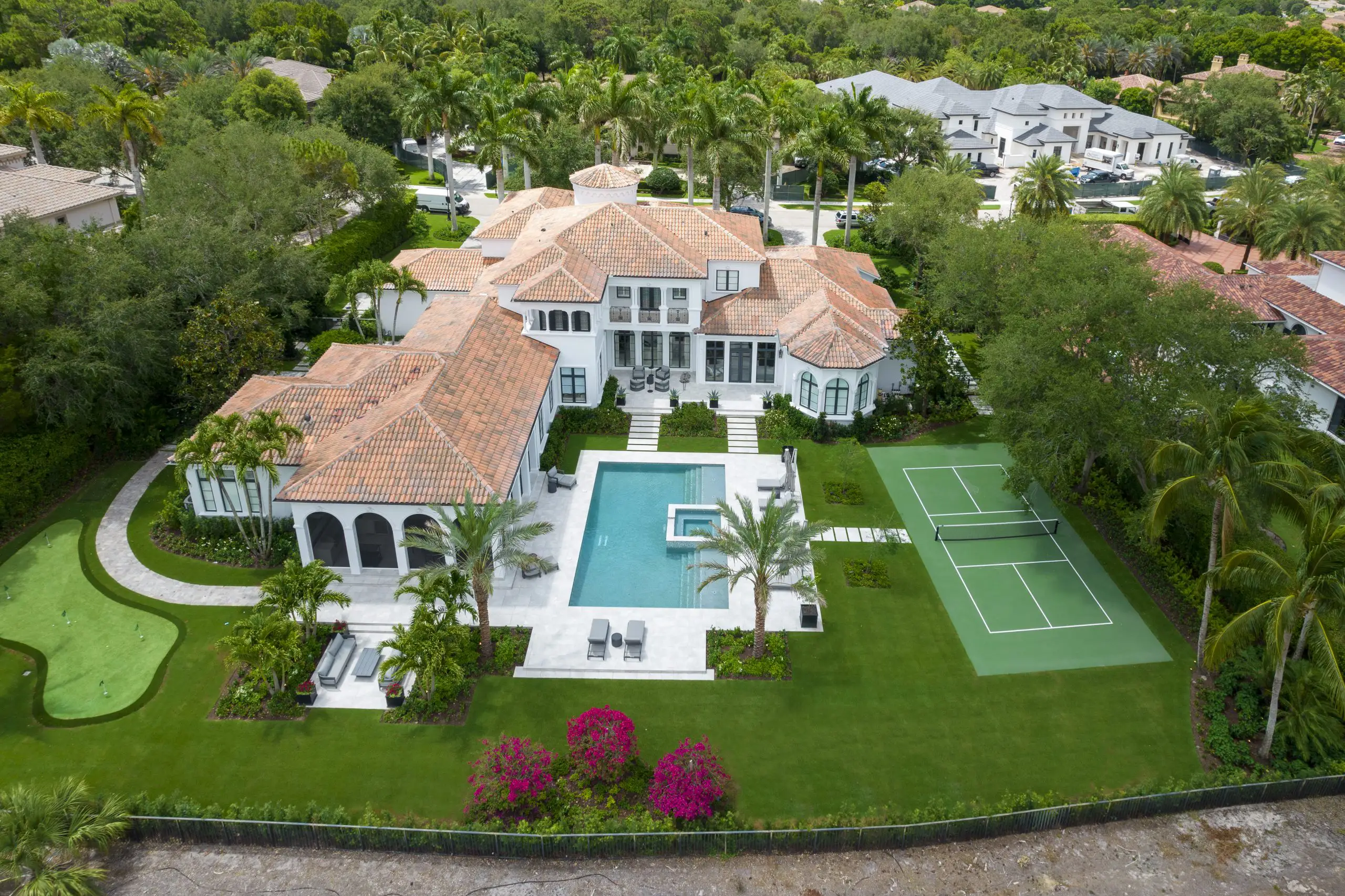 Luxurious Modern Mediterranean style Palm Beach residence captured from above, highlighting its stunning design and beautiful landscaping.