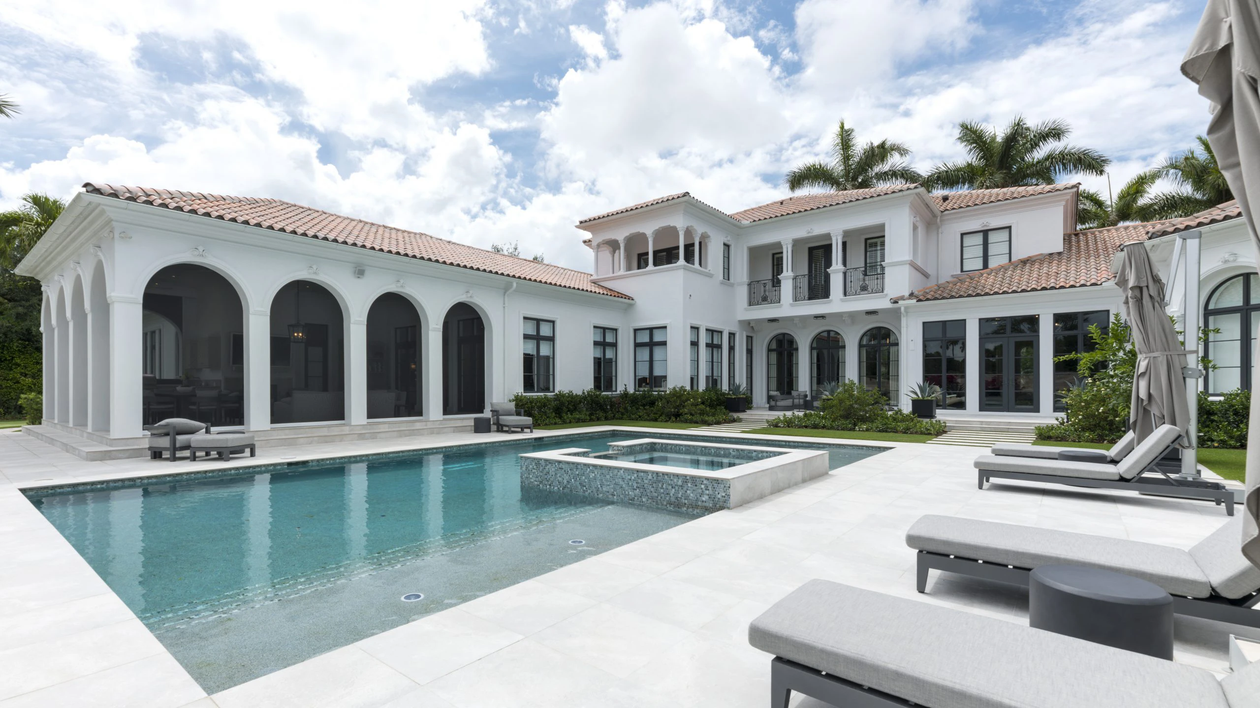 Grand white Modern Mediterranean house with a lovely pool and a stylish patio.