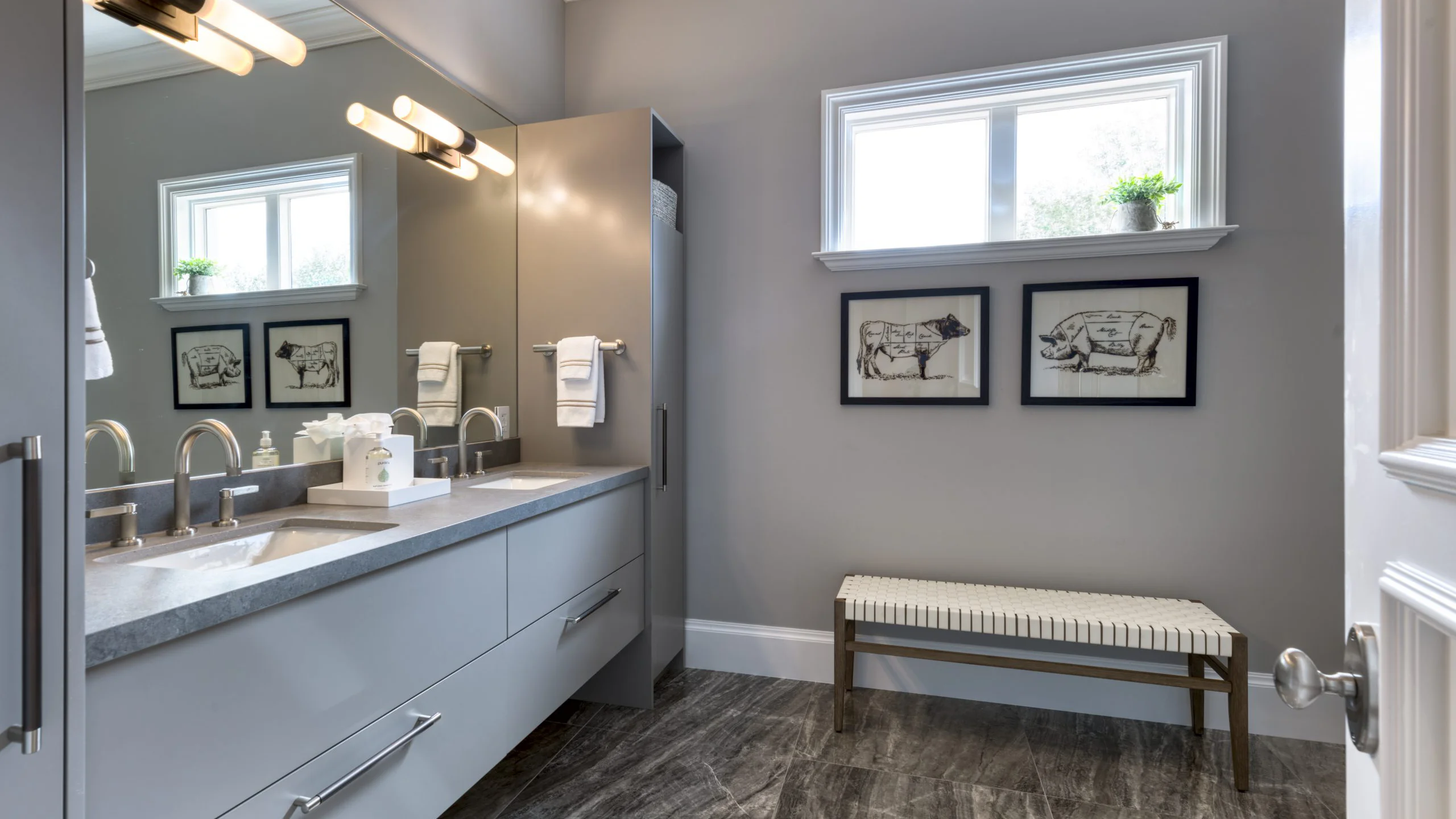 Contemporary bathroom with sleek gray cabinets and a practical bench for relaxation and storage.