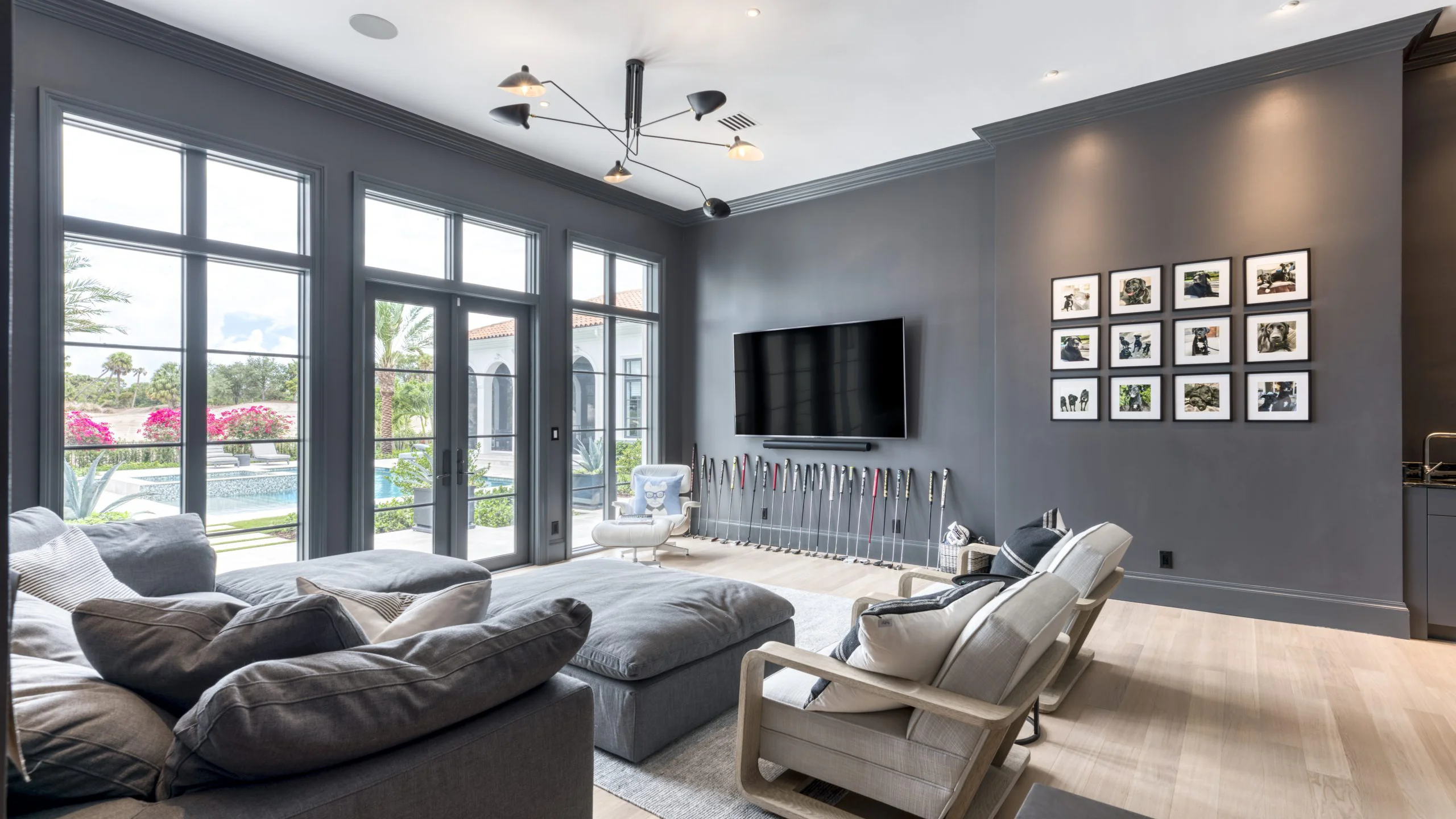 Modern living room featuring gray walls and a television.