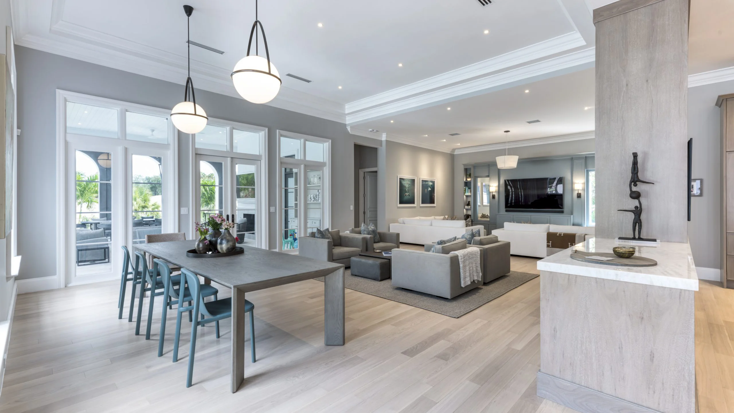 Modern interior featuring a living room and dining area with rich hardwood floors and chic furnishings.