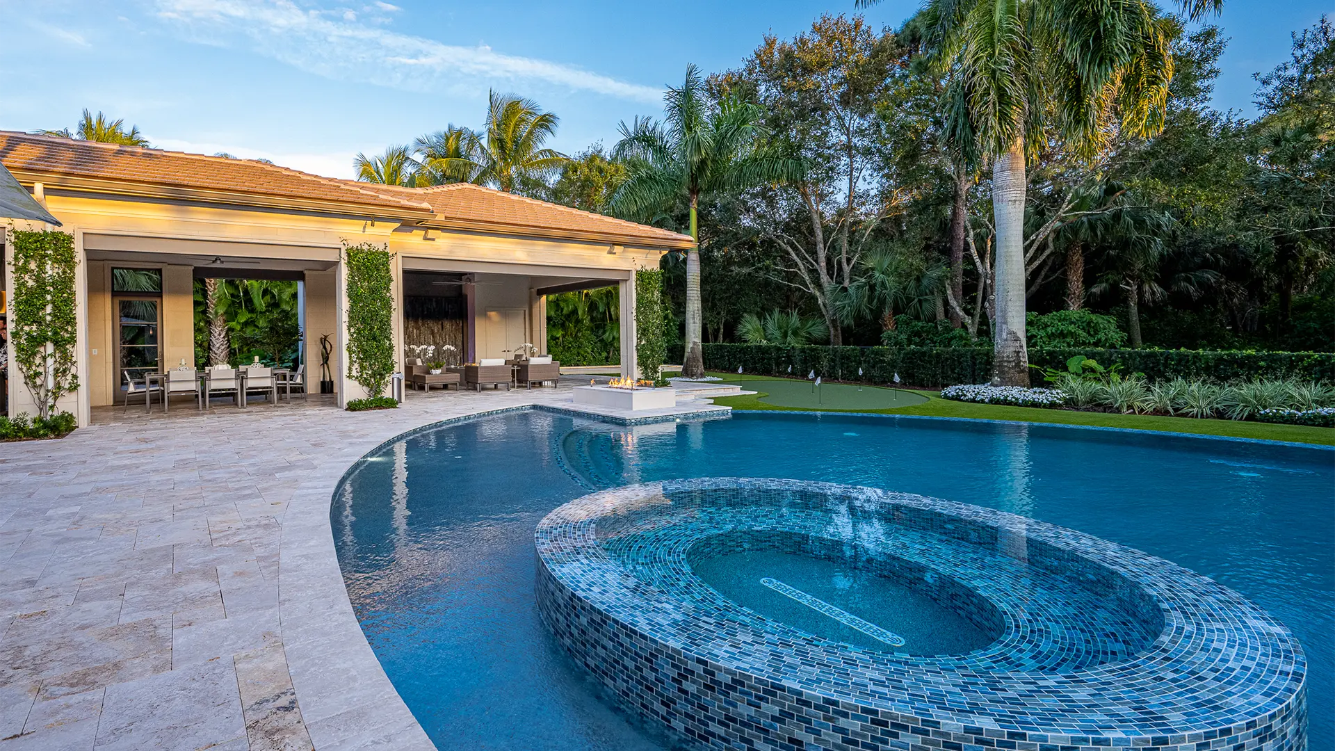 Sumptuous pool featuring an enchanting fountain, surrounded by a refined patio area.