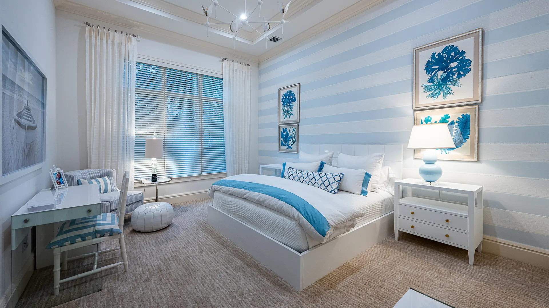 Tranquil bedroom featuring blue and light blue striped walls, complemented by white and cream accents.