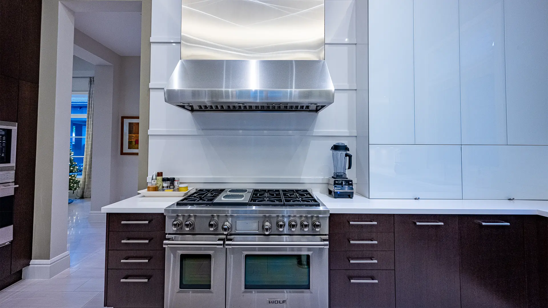 Kitchen featuring stainless steel appliances and an elegant range hood.