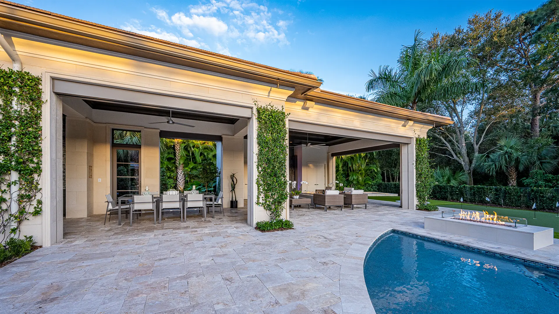 Inviting poolside patio with a fire pit and furniture.
