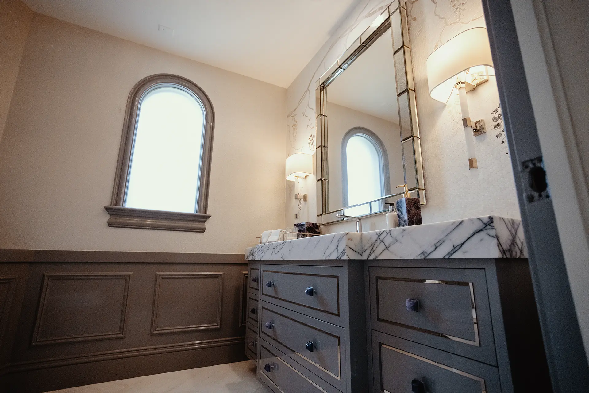 Luxurious bathroom featuring a High Gloss Lacquer Vanity in Moonlit Orchid, crowned with a 4-inch mitered Lilac Marble top, and a Wisteria Stone Waterjet Mosaic backdrop
